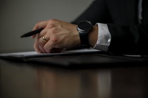Canton, GA lawyer holding a pen during a free consultation