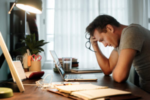 man stressed trying to decide on a personal injury lawyer