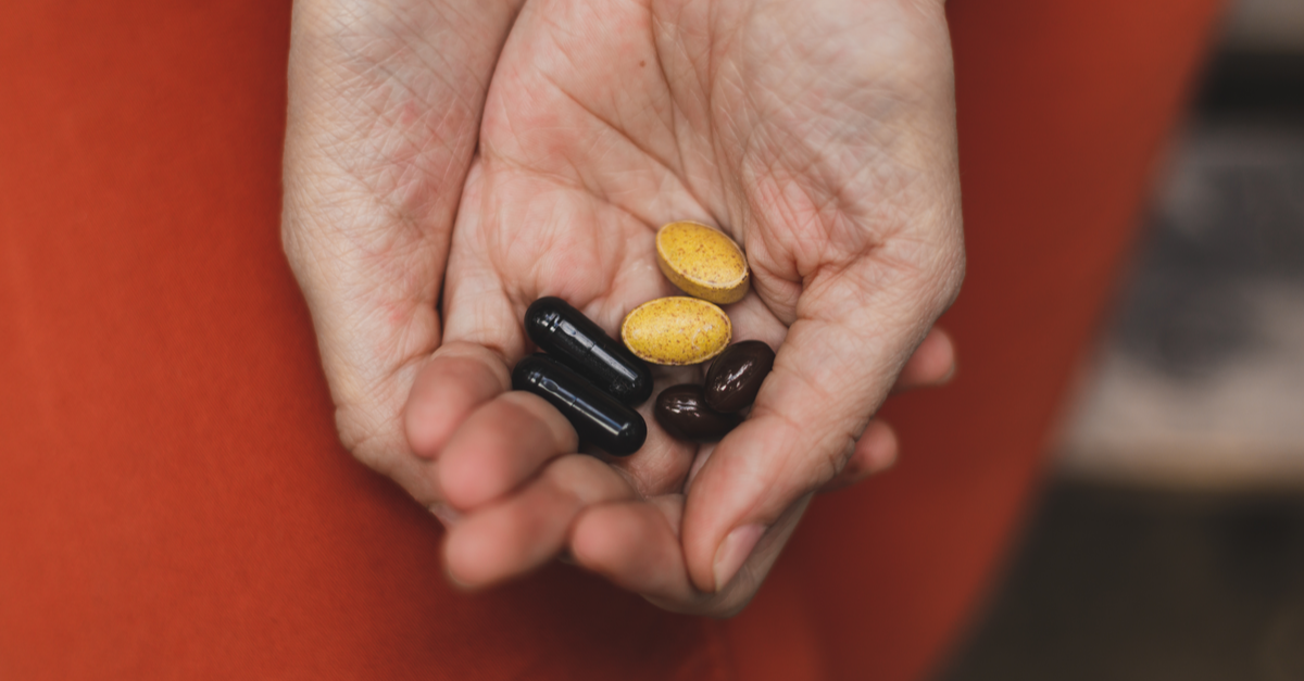 hands holding medicine pills