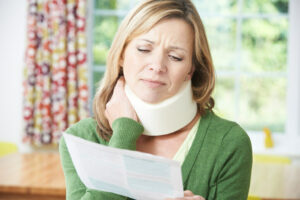 Injured woman looking at letter