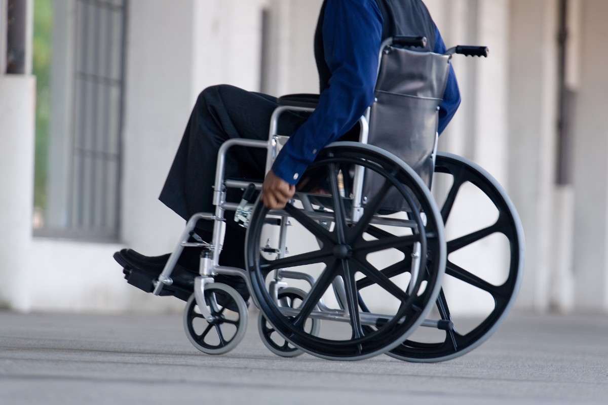 Paralyzed man using a wheelchair to move around